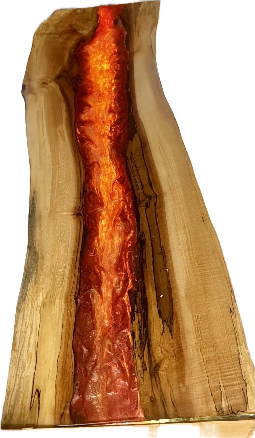 Finished live-edge wood and orange epoxy piece illuminated through the resin centre